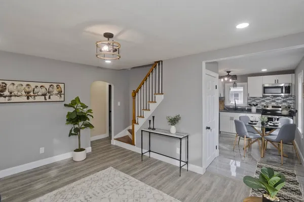 a living room with furniture and a dining table
