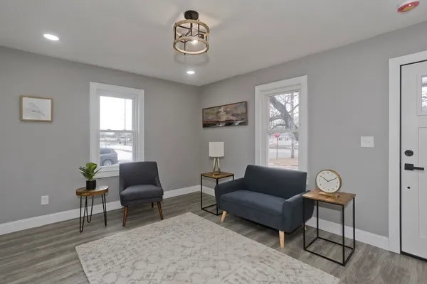 a living room with furniture a window and a clock