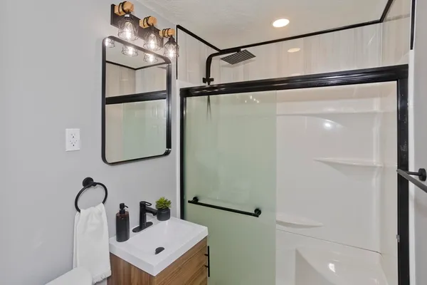 a bathroom with a sink and mirror