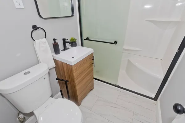 a white toilet sitting next to a bathroom sink
