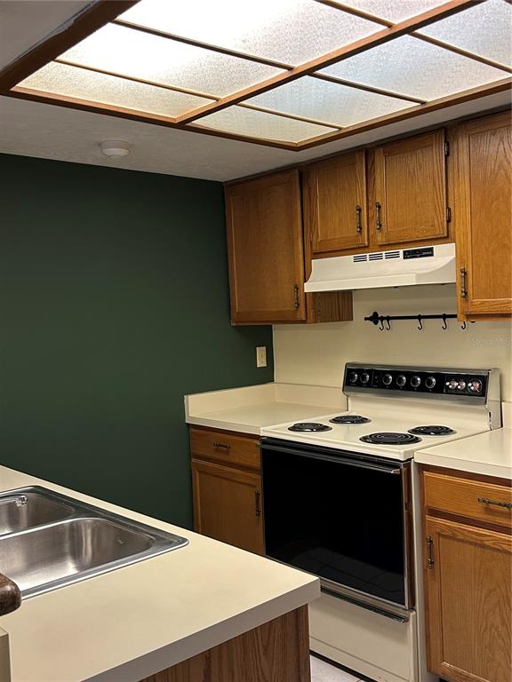 822 Southwest 56th Terrace Gainesville, FL 32607 - Photo 3 of 4 a kitchen with a stove and a sink