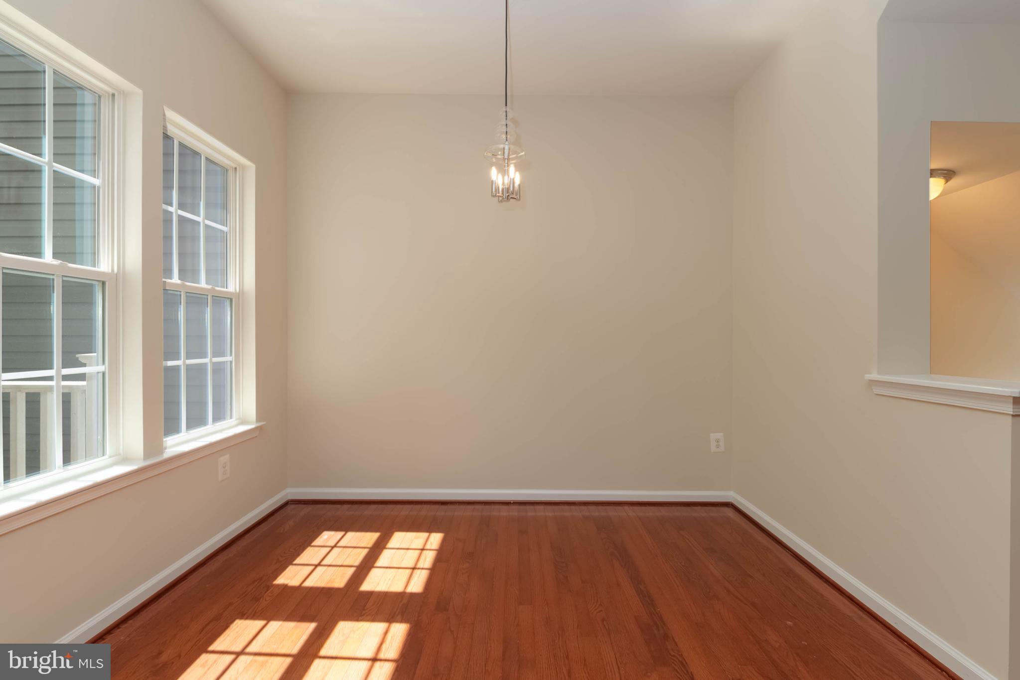 405 Signal Court, Unit 33 Bel Air, MD 21014 - Photo 12 of 43 a view of an empty room with wooden floor and a window
