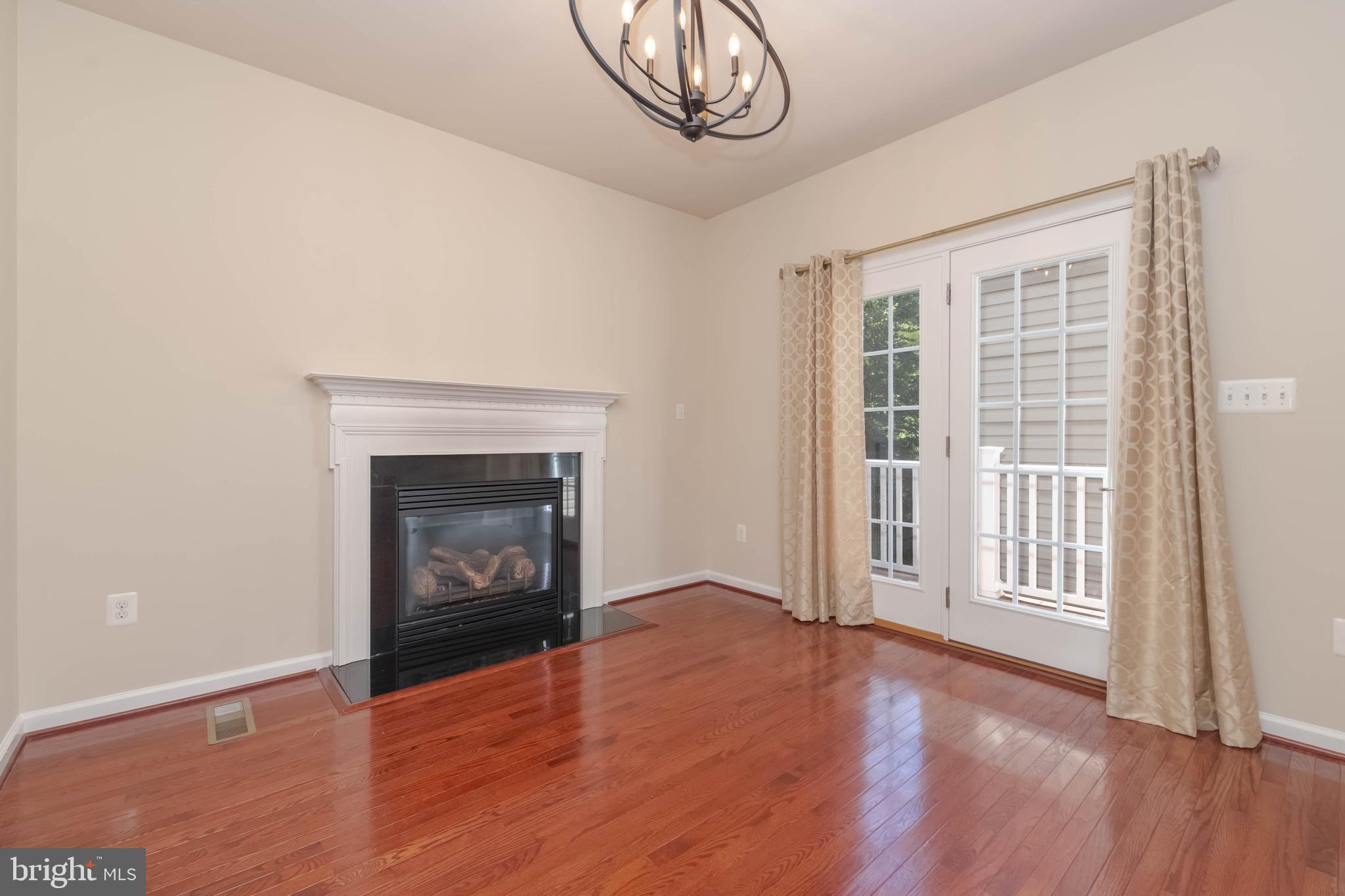 405 Signal Court, Unit 33 Bel Air, MD 21014 - Photo 14 of 43 an empty room with wooden floor a fireplace and windows