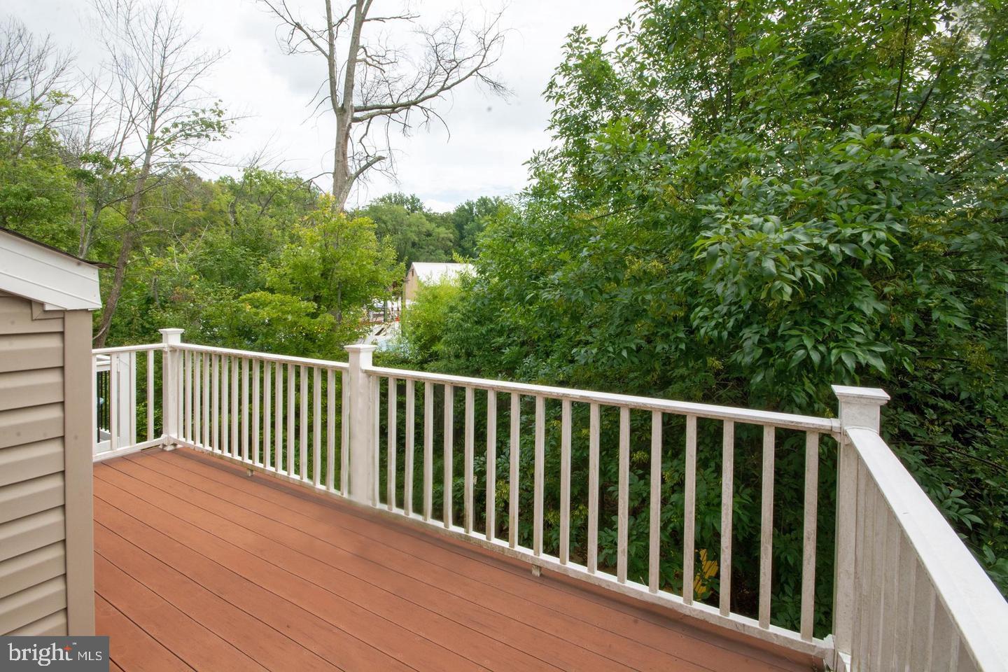 405 Signal Court, Unit 33 Bel Air, MD 21014 - Photo 17 of 43 a balcony with wooden floor and fence