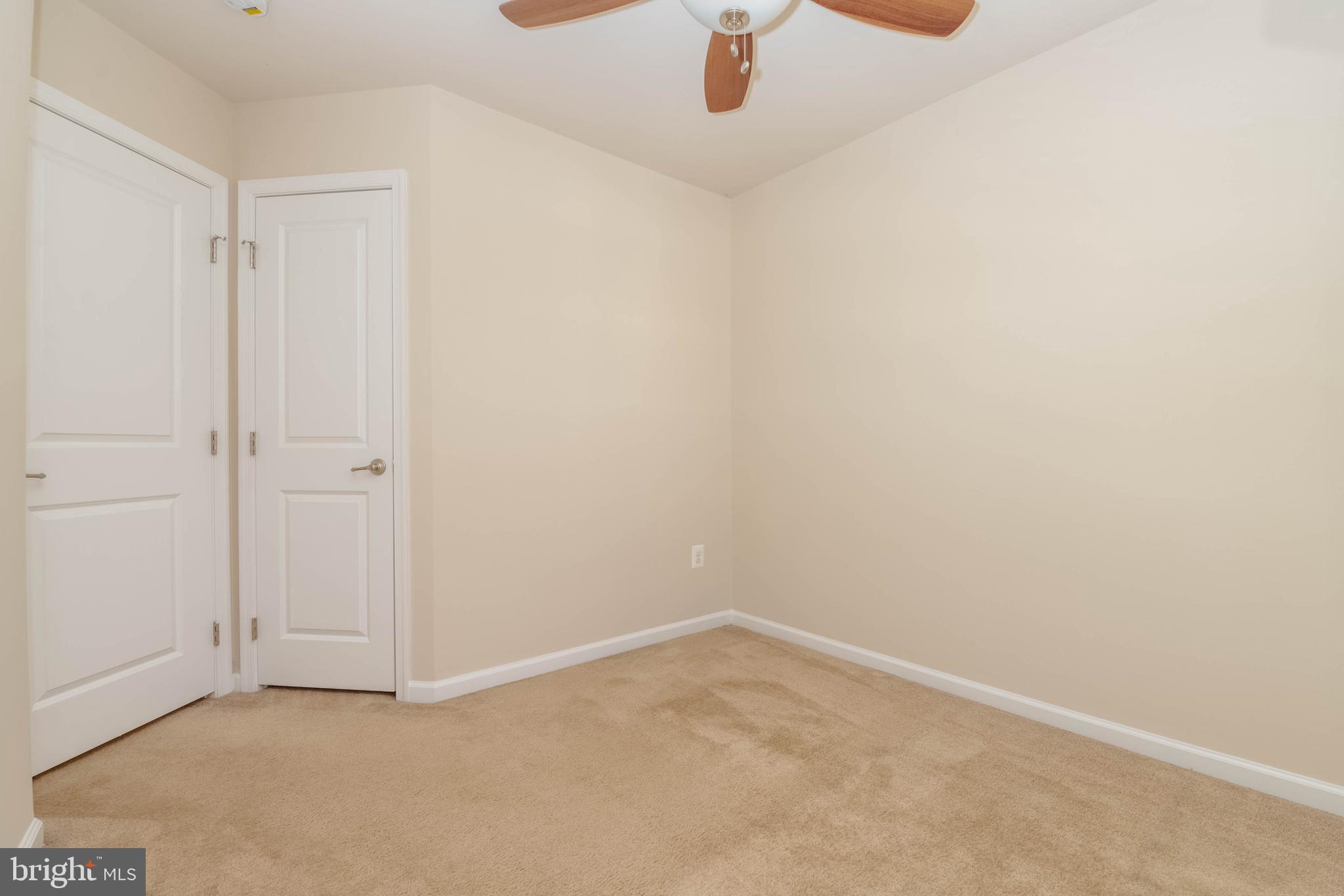 405 Signal Court, Unit 33 Bel Air, MD 21014 - Photo 28 of 43 an empty room with a ceiling fan and carpet