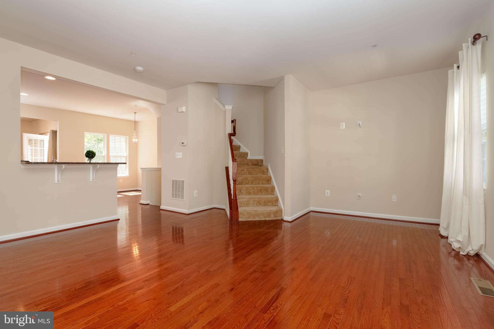 405 Signal Court, Unit 33 Bel Air, MD 21014 - Photo 4 of 43 wooden floor in an empty room with a window