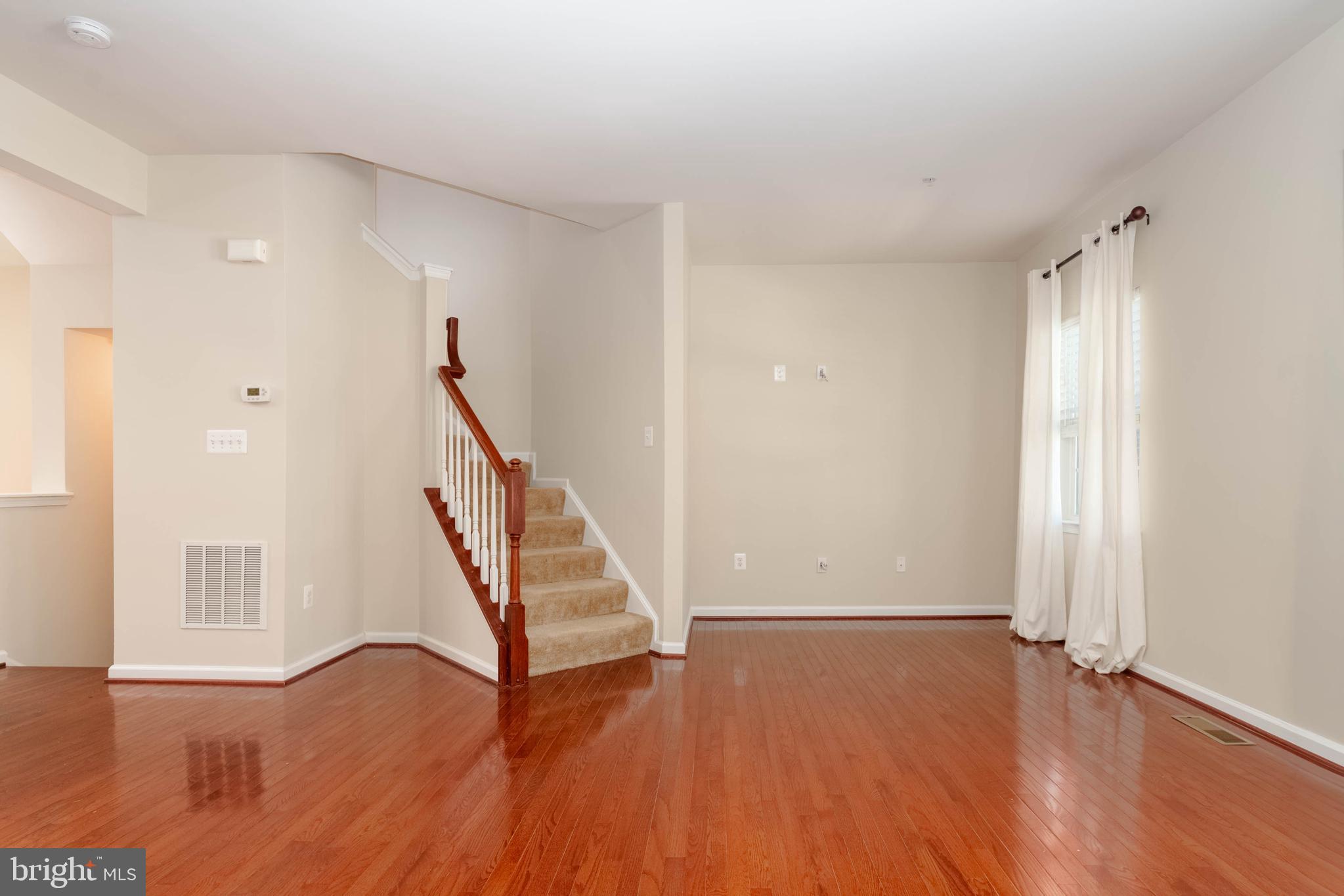 405 Signal Court, Unit 33 Bel Air, MD 21014 - Photo 5 of 43 a view of an empty room with wooden floor and stairs