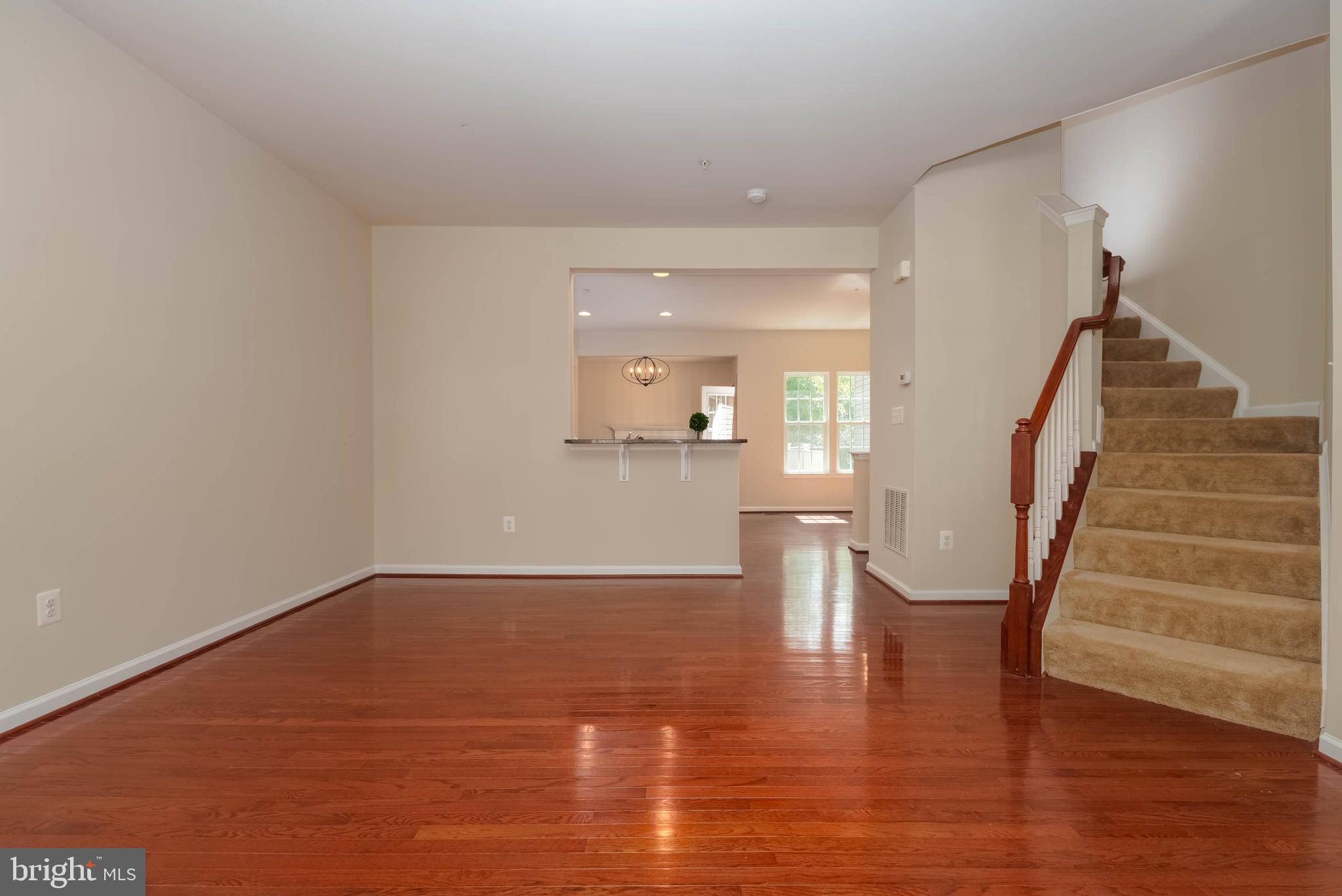 405 Signal Court, Unit 33 Bel Air, MD 21014 - Photo 43 of 43 a view of an empty room with wooden floor and stairs