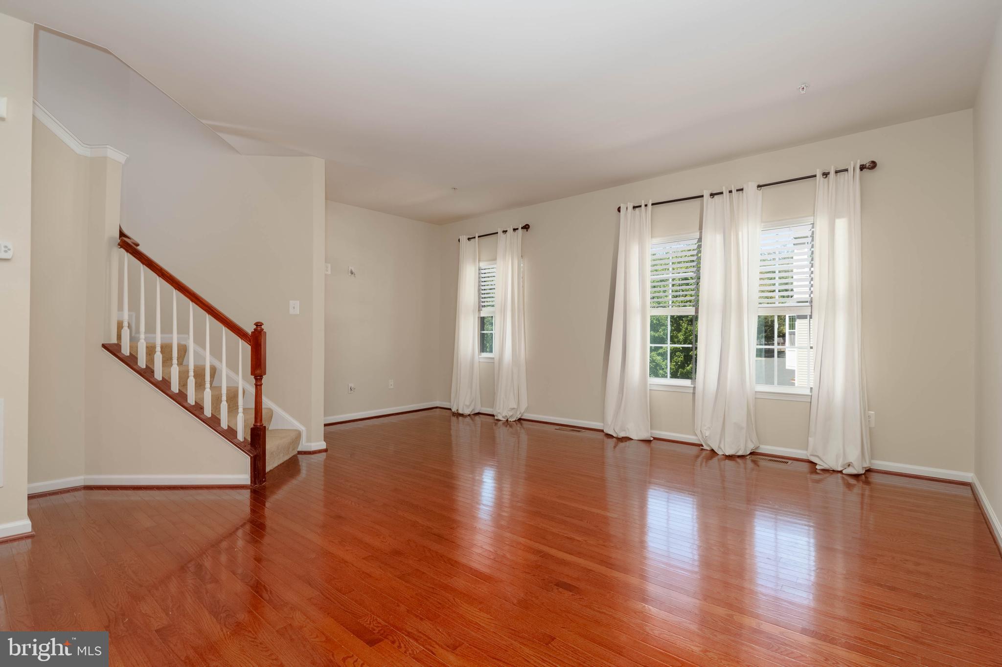405 Signal Court, Unit 33 Bel Air, MD 21014 - Photo 6 of 43 a view of an empty room with wooden floor and a window