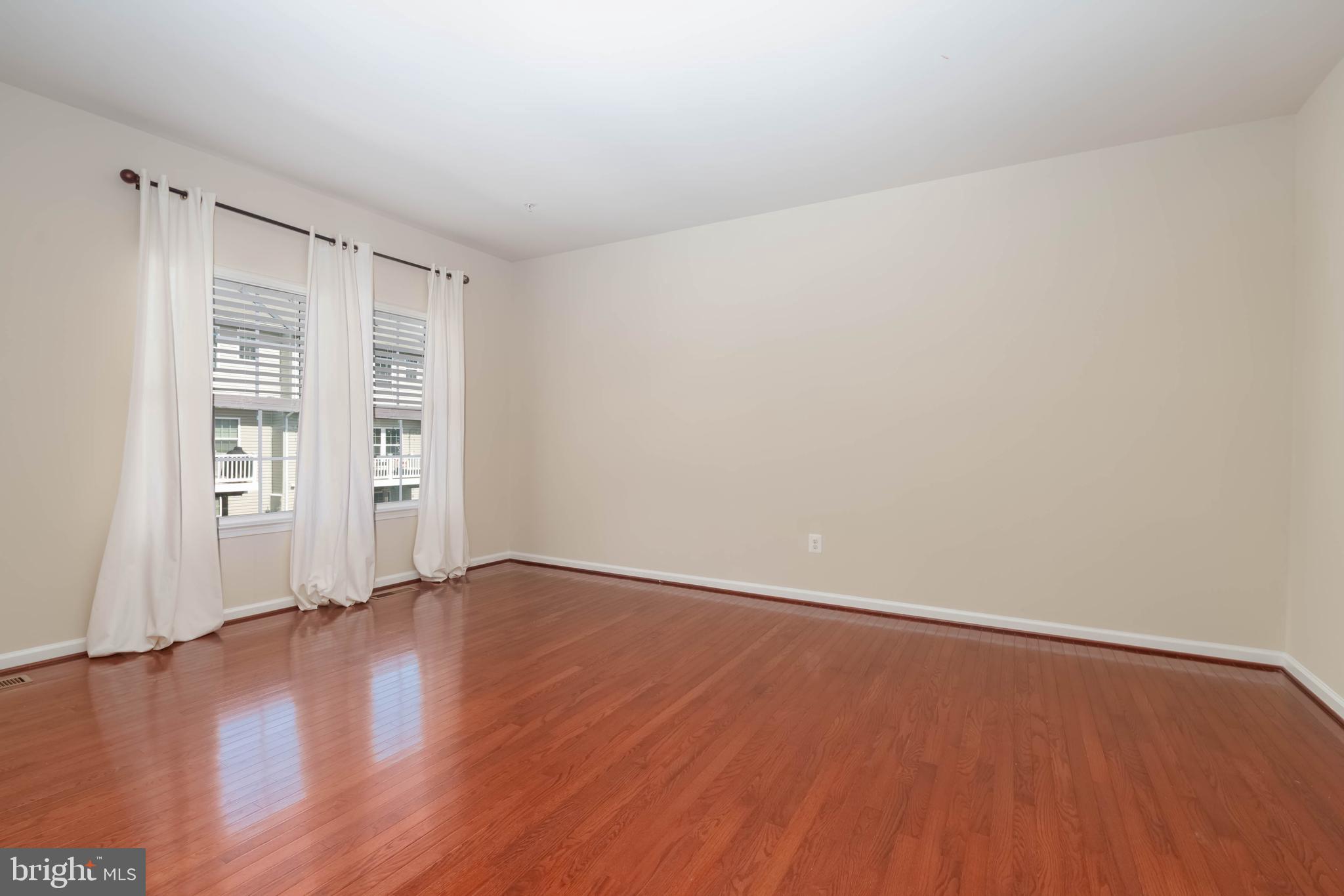 405 Signal Court, Unit 33 Bel Air, MD 21014 - Photo 7 of 43 an empty room with wooden floor and windows