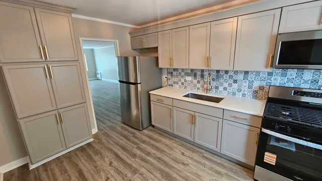 a kitchen with a refrigerator sink and stove