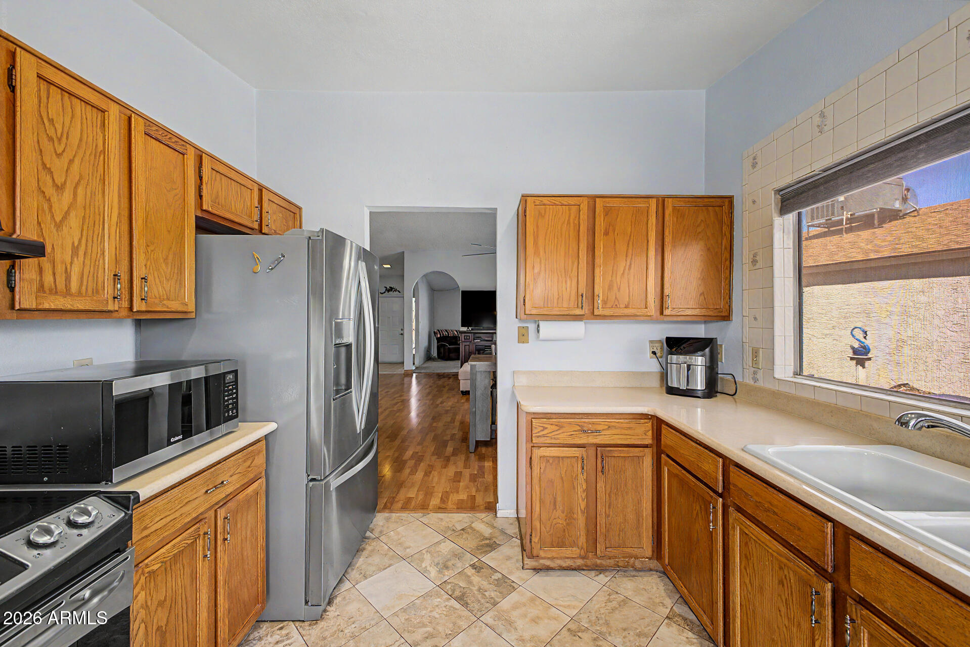 2659 West Hearn Road Phoenix, AZ 85023 - Photo 11 of 25 a kitchen with a sink refrigerator and microwave