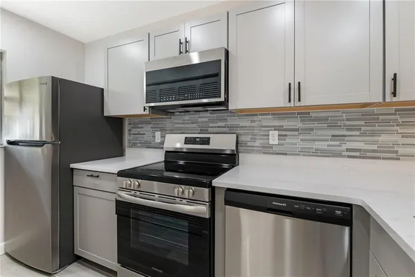 a kitchen with a stove microwave and refrigerator