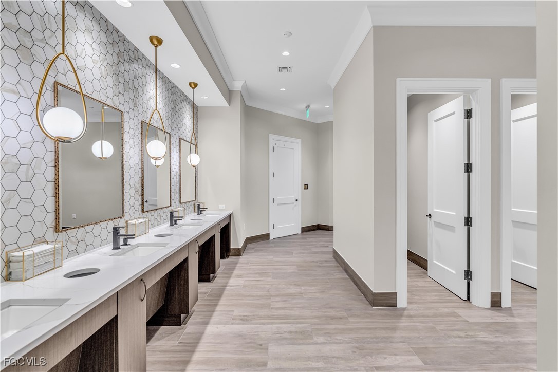 43985 Boardwalk Loop, Unit 2135 Punta Gorda, FL 33982 - Photo 44 of 48 a large bathroom with a double vanity sink and a mirror