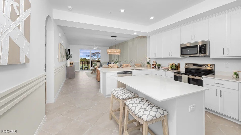 43985 Boardwalk Loop, Unit 2135 Punta Gorda, FL 33982 - Photo 6 of 48 a open kitchen with stainless steel appliances granite countertop a stove top oven a sink a refrigerator and white cabinets