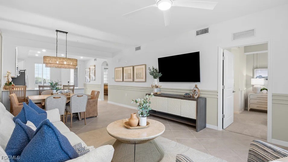 43985 Boardwalk Loop, Unit 2135 Punta Gorda, FL 33982 - Photo 9 of 48 a living room with furniture a flat screen tv and kitchen view