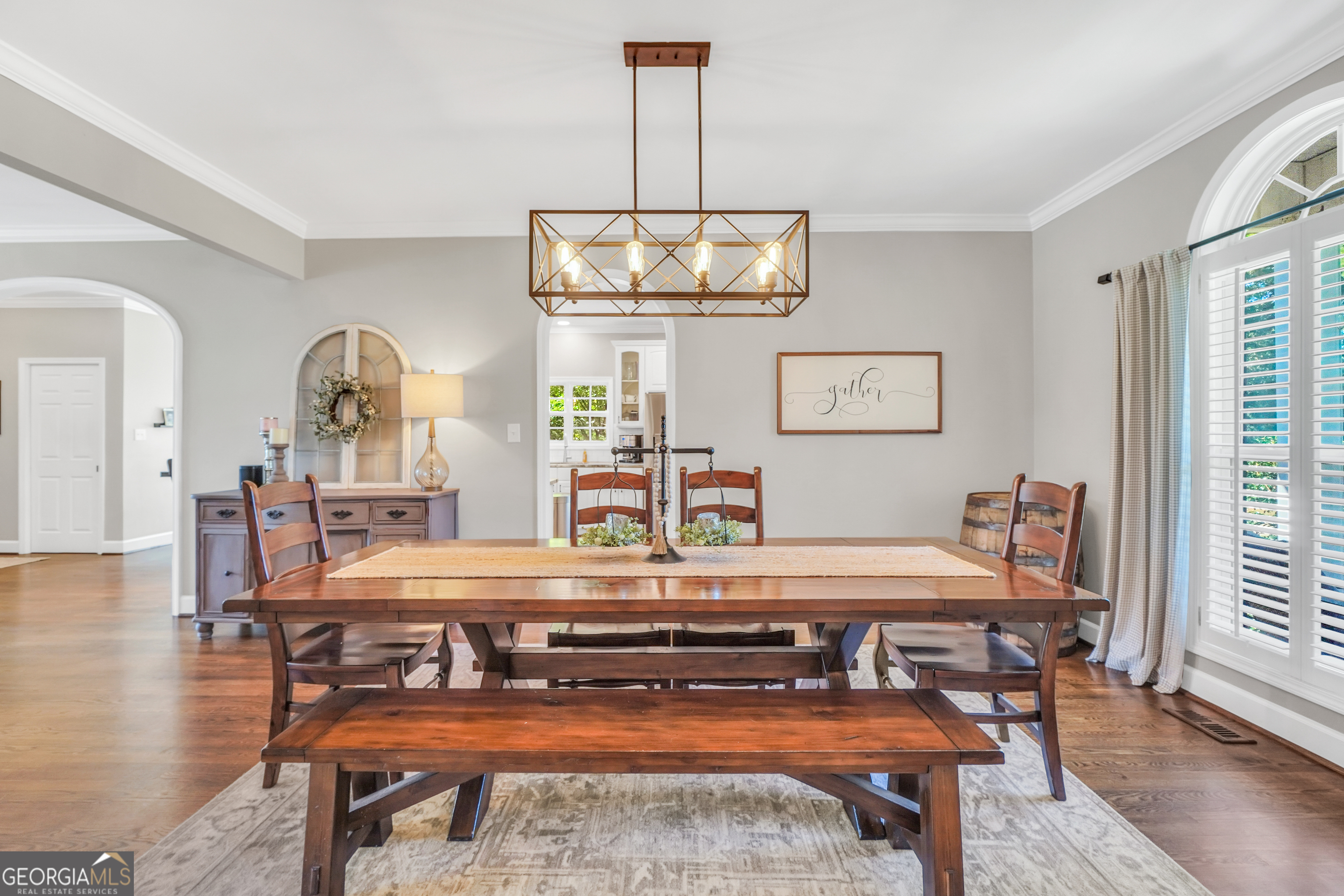 1964 East Lake Road McDonough, GA 30252 - Photo 15 of 99 a dining room with wooden floor a chandelier a wooden table and chairs