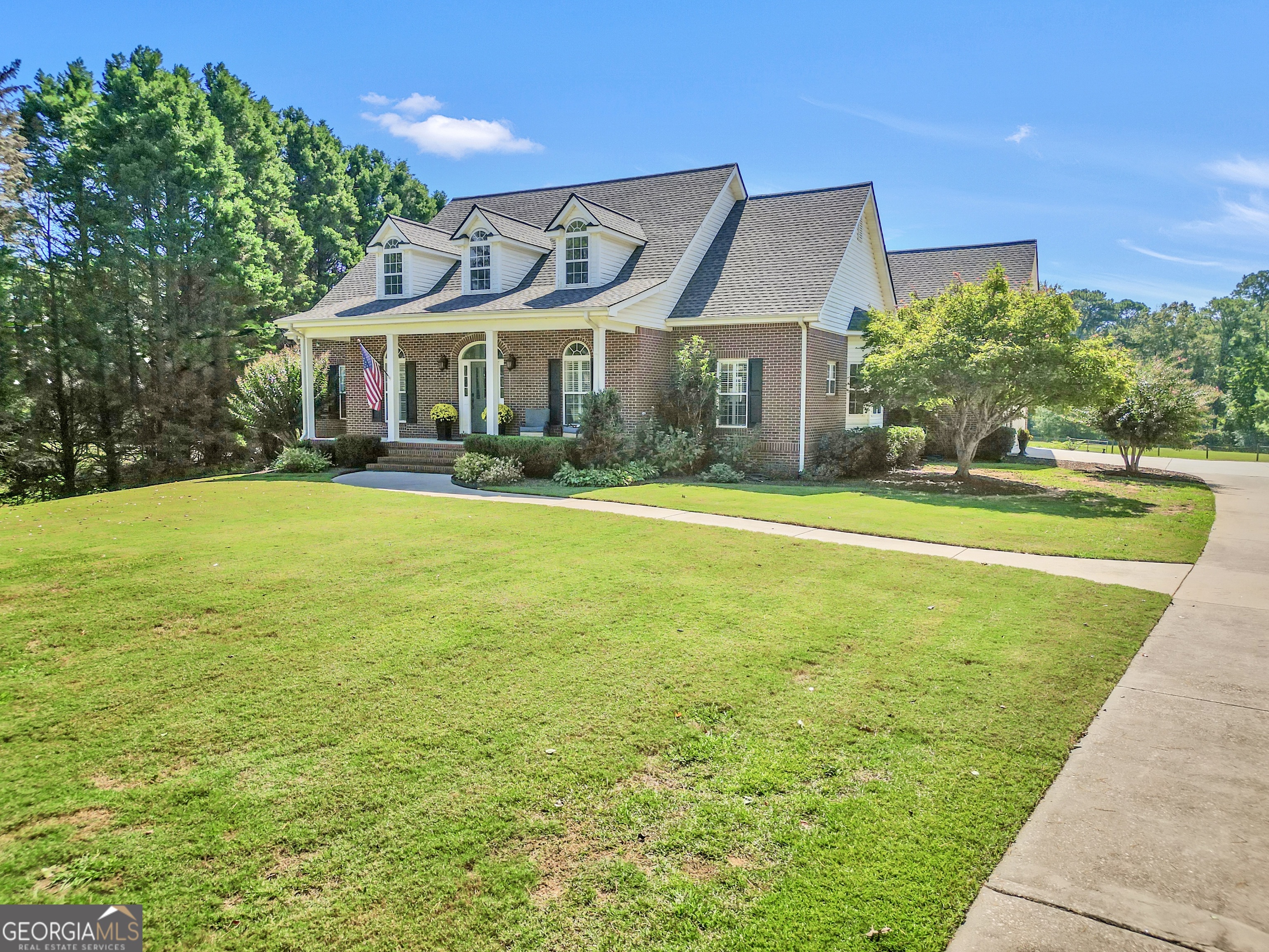 1964 East Lake Road McDonough, GA 30252 - Photo 3 of 99 a view of a big house with a big yard and large trees