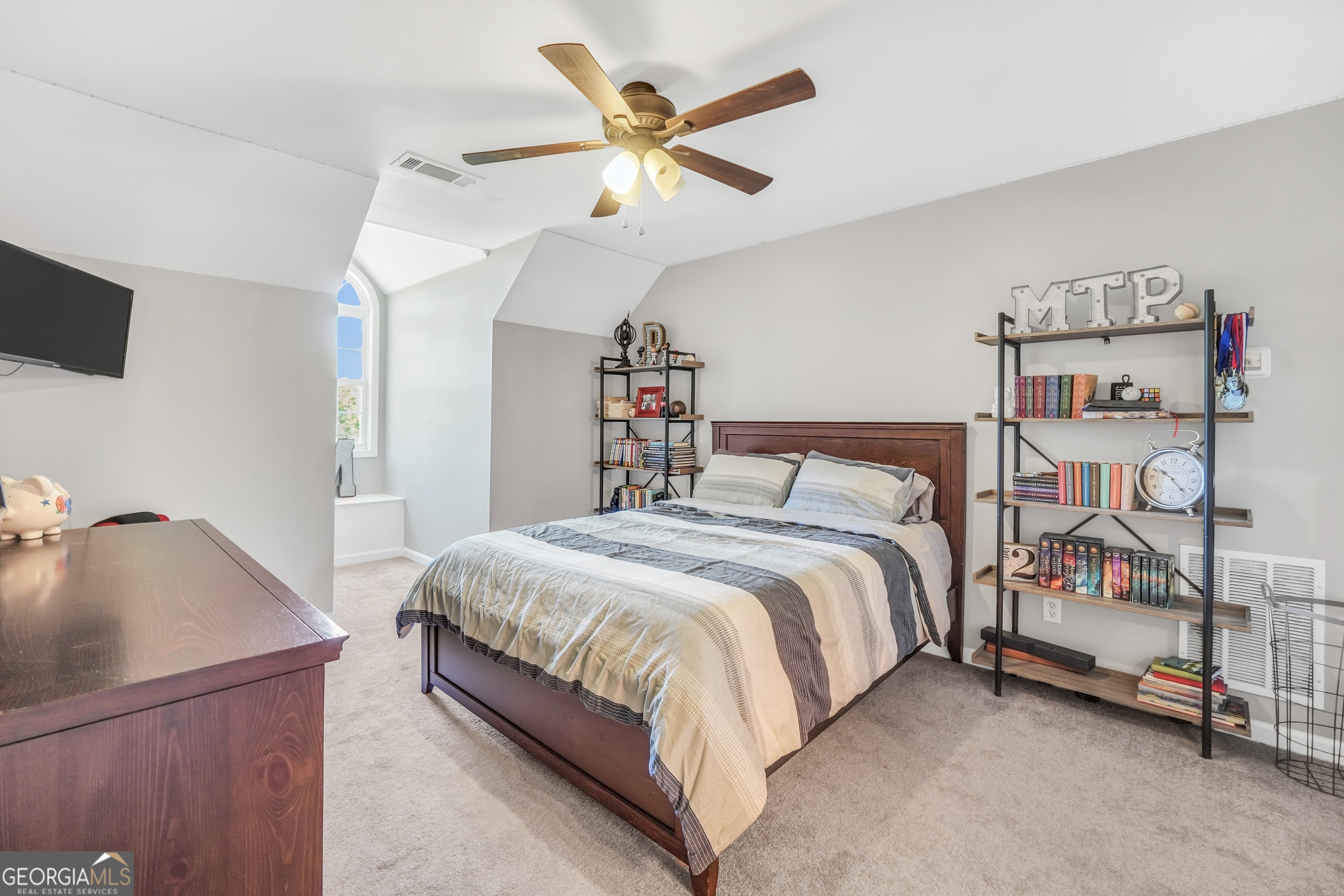 1964 East Lake Road McDonough, GA 30252 - Photo 45 of 99 a bedroom with a bed and a chandelier