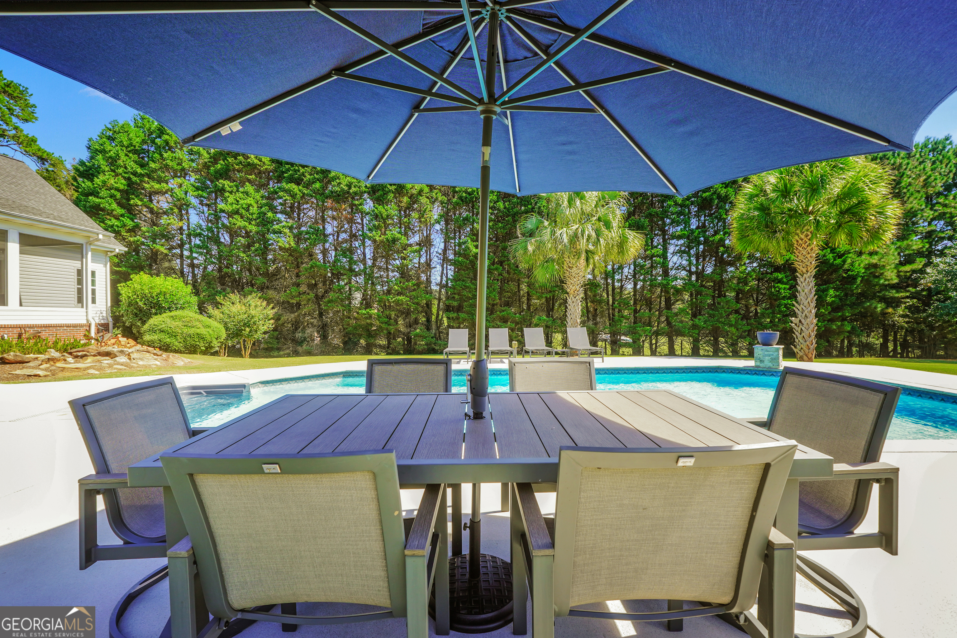 1964 East Lake Road McDonough, GA 30252 - Photo 74 of 99 a view of an outdoor sitting area with furniture and umbrella