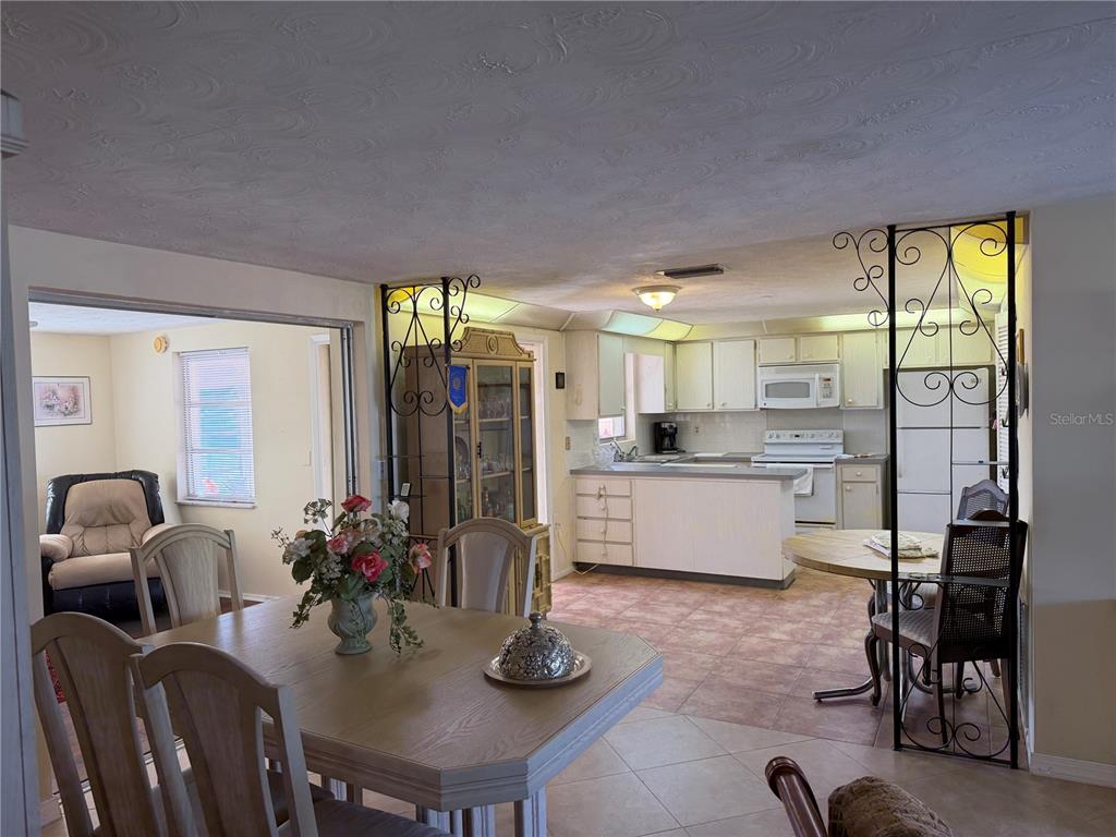 3914 Carioca Road Holiday, FL 34691 - Photo 20 of 23 a kitchen with a table chairs refrigerator and cabinets