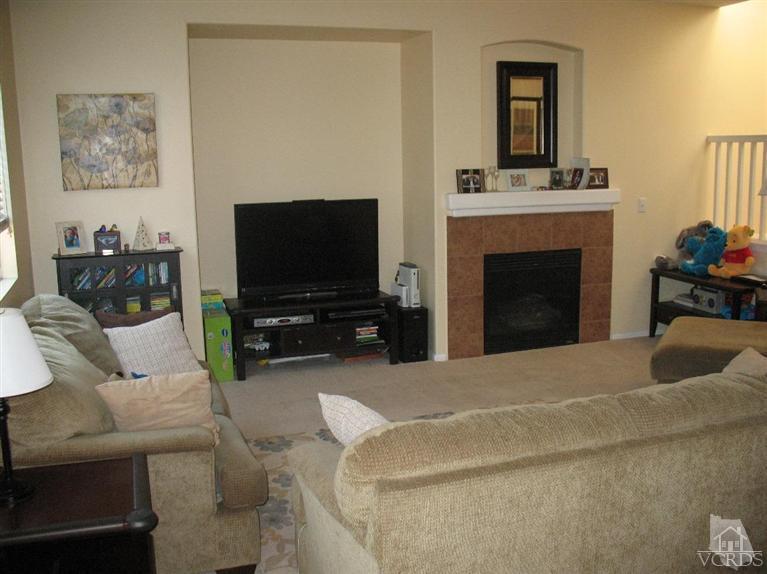 1420 Quincy Street Oxnard, CA 93033 - Photo 2 of 27 a living room with furniture a flat screen tv and a fireplace
