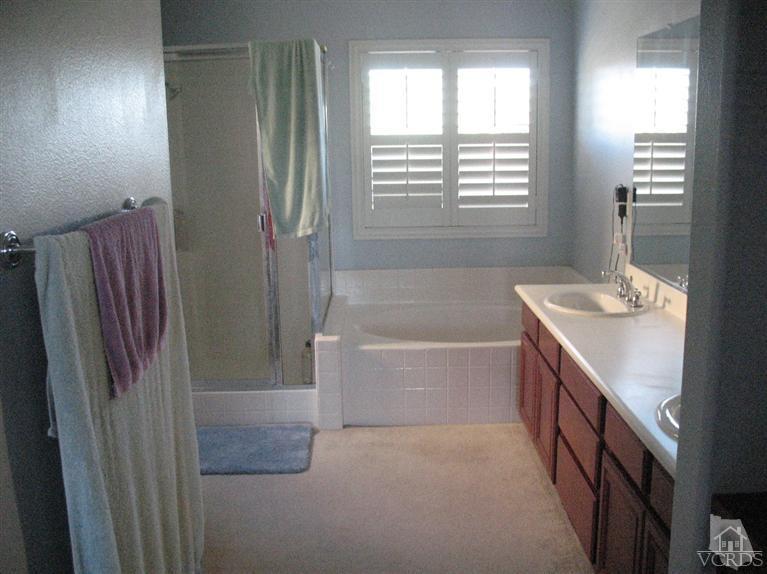 1420 Quincy Street Oxnard, CA 93033 - Photo 14 of 27 a spacious bathroom with a bathtub and a sink