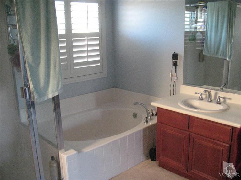 1420 Quincy Street Oxnard, CA 93033 - Photo 15 of 27 a bathroom with a tub sink and mirror