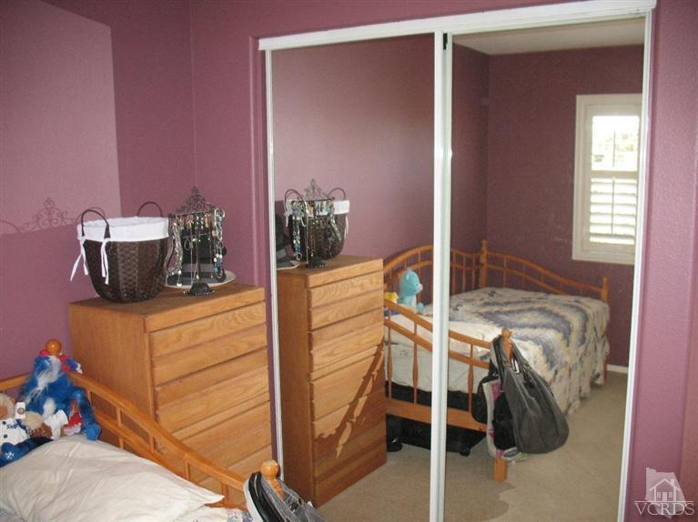 1420 Quincy Street Oxnard, CA 93033 - Photo 18 of 27 a bedroom with a bed and potted plant