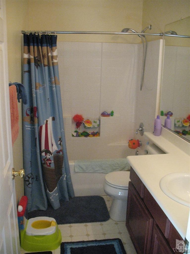 1420 Quincy Street Oxnard, CA 93033 - Photo 25 of 27 a bathroom with a sink vanity mirror and toilet