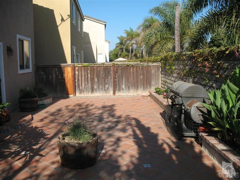 1420 Quincy Street Oxnard, CA 93033 - Photo 10 of 27 a backyard of a house with table and chairs and potted plants