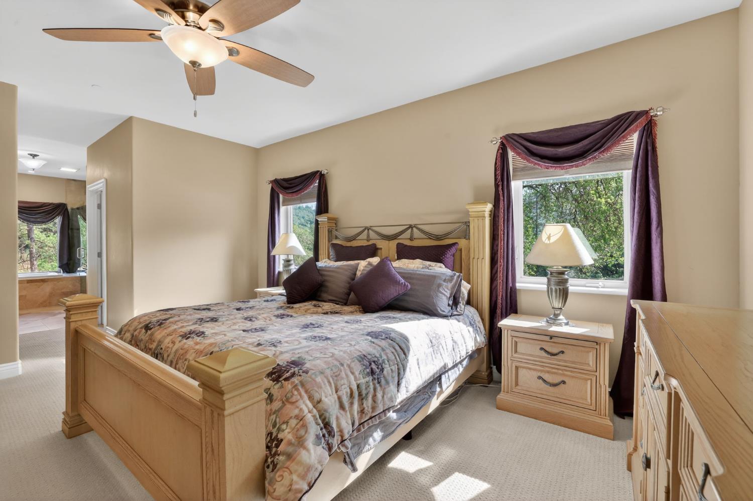 4554 Cross Creek Road Cool, CA 95614 - Photo 29 of 92 a bedroom with a bed and a chandelier