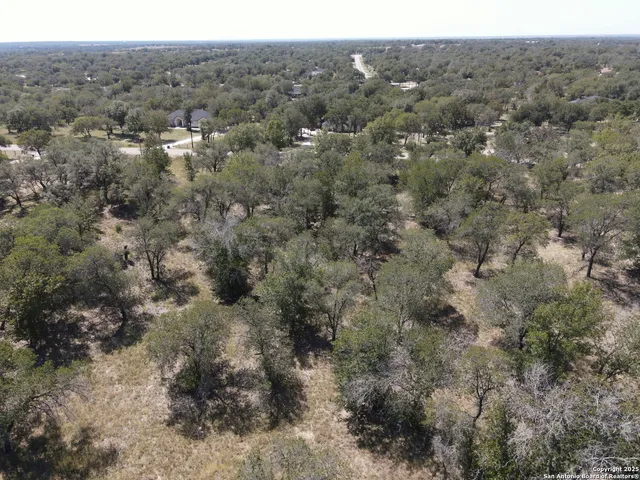 an aerial view of house with yard and mountain view