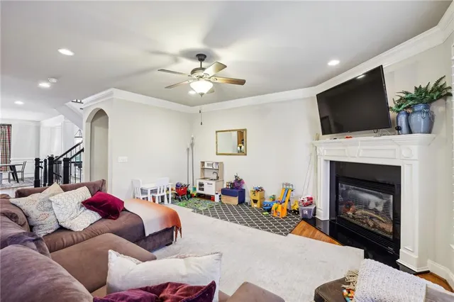 a living room with furniture a fireplace and a flat screen tv
