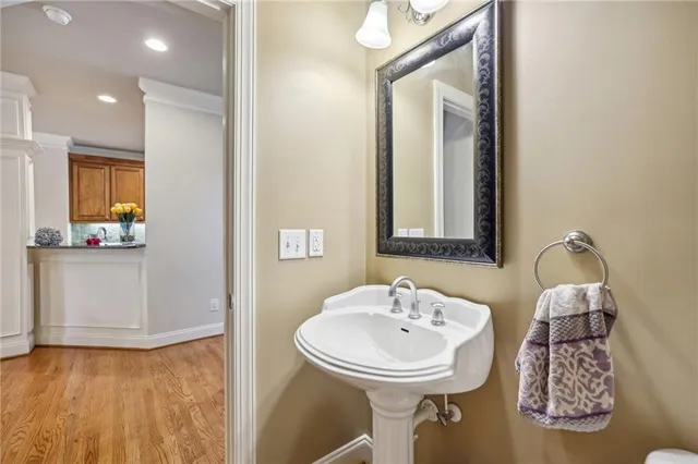 a bathroom with a sink mirror and tub