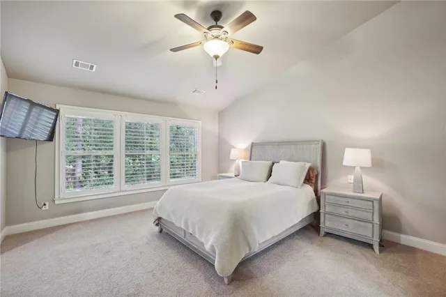 a bedroom with a bed and a large window