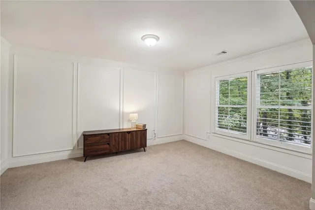 an empty room with large windows