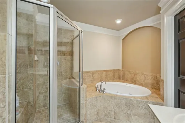 a bathroom with a bathtub and shower