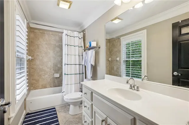 a bathroom with a sink toilet tub and shower