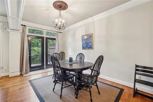 a view of a dining room with furniture wooden floor and chandelier