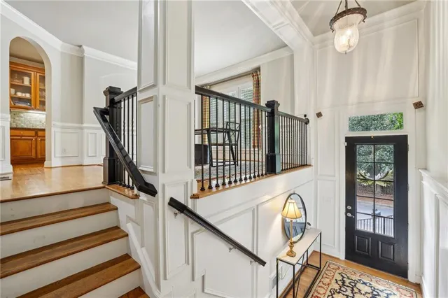 a view of entryway and hall with wooden floor