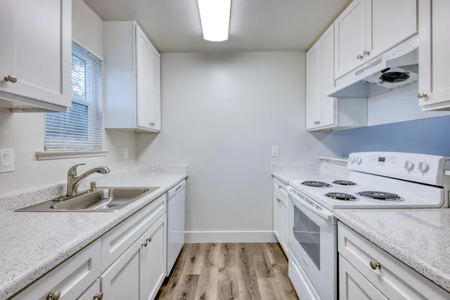 a kitchen with sink cabinets and stove