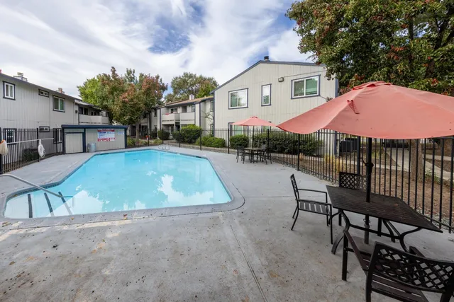 a view of a house with backyard and sitting area