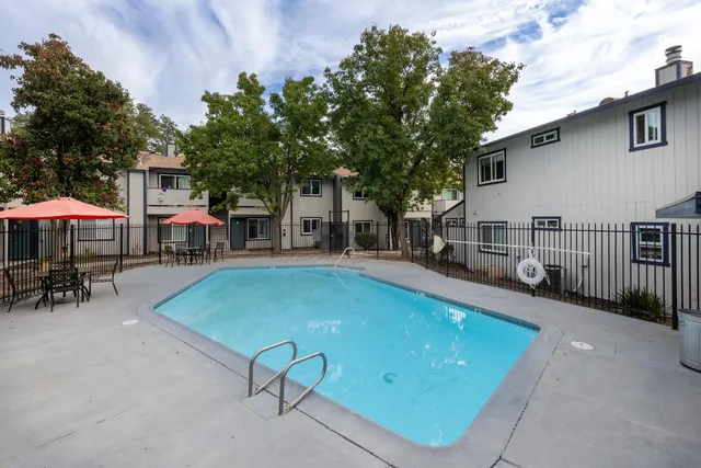 a view of a house with swimming pool and sitting area