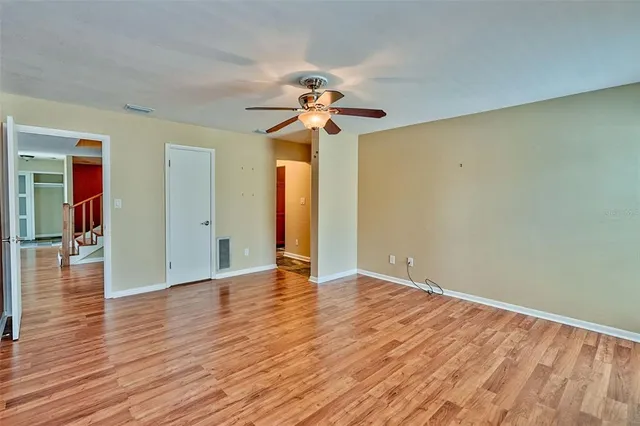 a view of an empty room with wooden floor