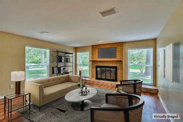 a living room with furniture and a fireplace