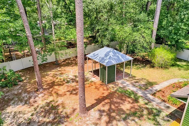 a backyard of a house with table and chairs