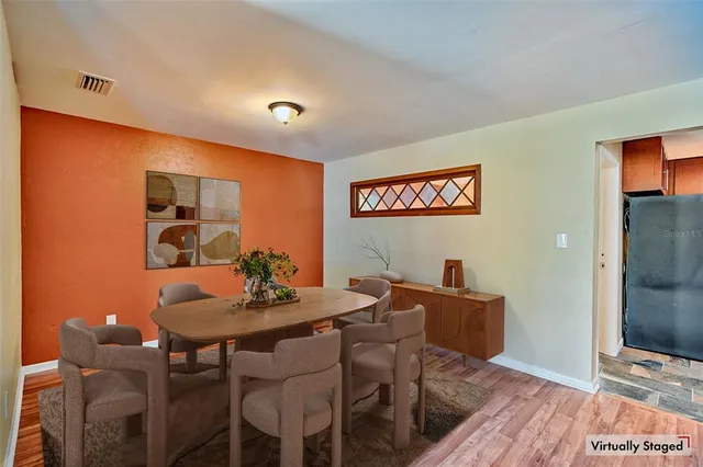 a view of a dining room with furniture and wooden floor