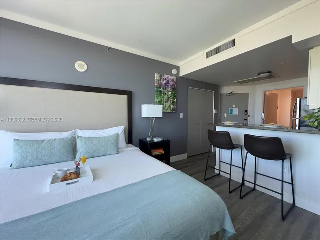 a bedroom with a bed and a potted plant