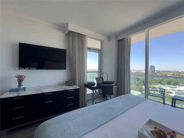 a bedroom with a bed and a flat screen tv